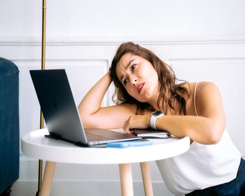 Person looking away from computer screen taking a break