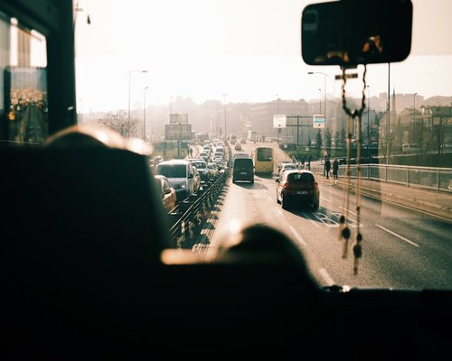 Traffic and busy street seen from bus