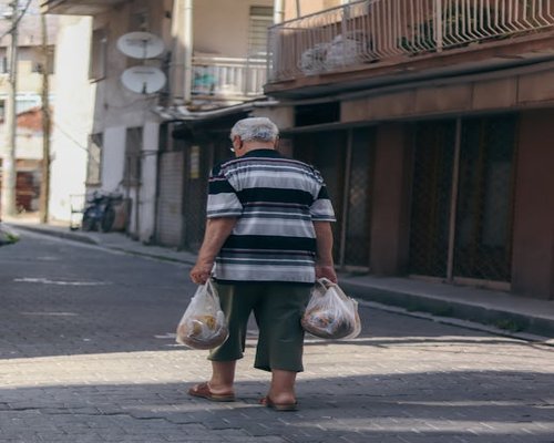 Person carrying groceries comfortably in an urban street