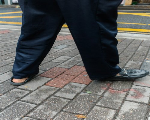 Detail of comfortable shoes stepping on the sidewalk